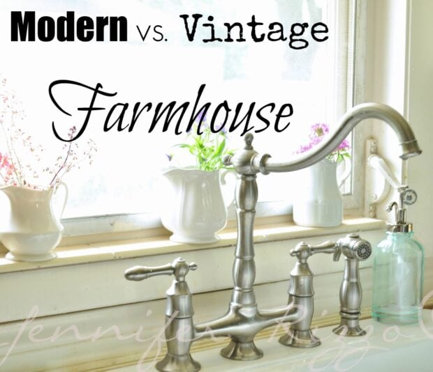 A silver farmhouse-style kitchen faucet with three handles is set in front of a window, surrounded by white pitchers and a glass soap dispenser. Text above reads "Modern vs. vintage farmhouse," highlighting the blend of classic and contemporary design.