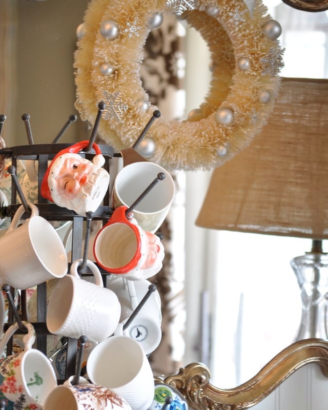 use a Bottle drying rack to hold vintage santa mugs