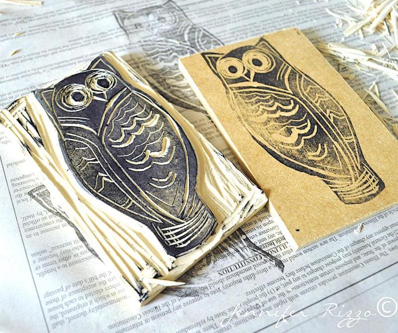A carved rubber owl stamp and its ink print on brown paper are displayed on a sheet of newspaper, surrounded by small carving debris—a perfect inspiration to carve your own rubber stamps.