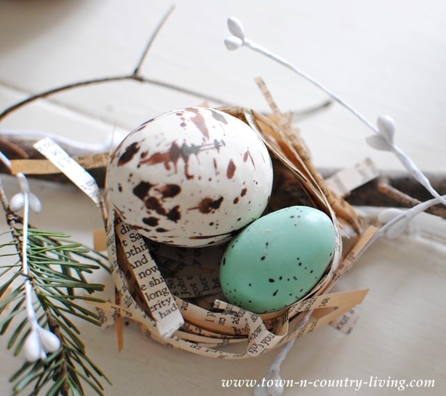 Faux eggs in book page nests