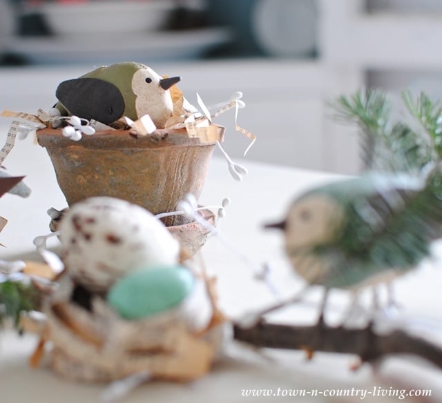 Little birds in terra cotta pots and shredded book pages