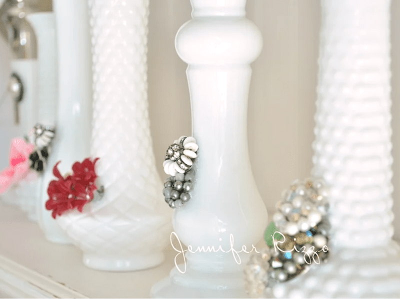 Several white glass vases are upcycled with broken jewelry, creating colorful vintage designs; the text "Jennifer Rizzo" appears on the image.