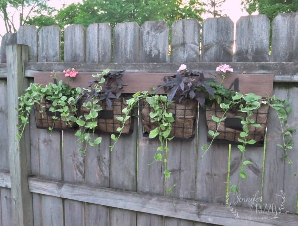 Idea for a hang on the farmhouse fence planter for geraniums and trailing vines from Jennifer Rizzo