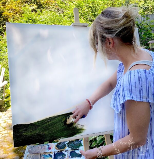 Paint a dark green base color on your canvas to create an abstract landscape