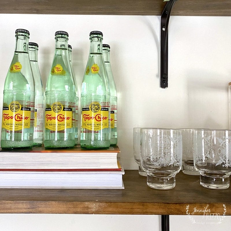 VIntage glasses and topo chico water on open shelving