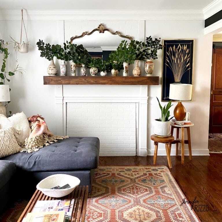 Living room with smoke bush clippings in vintage vases on mantel