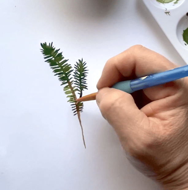 Continue to paint in the pine branch with green paint