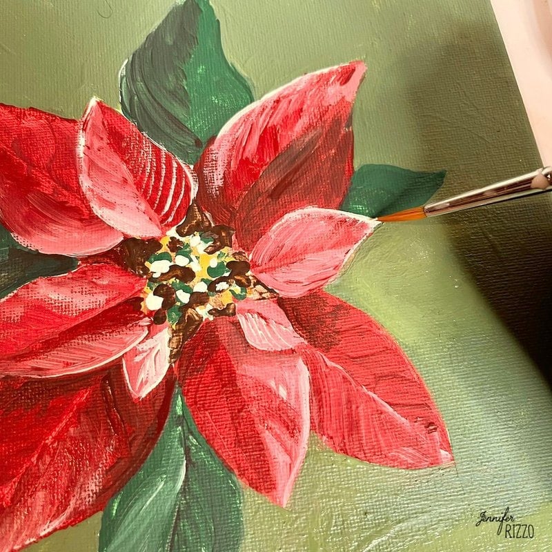 Add white paint to highlight the edges of the poinsettia and paint an easy poinsettia