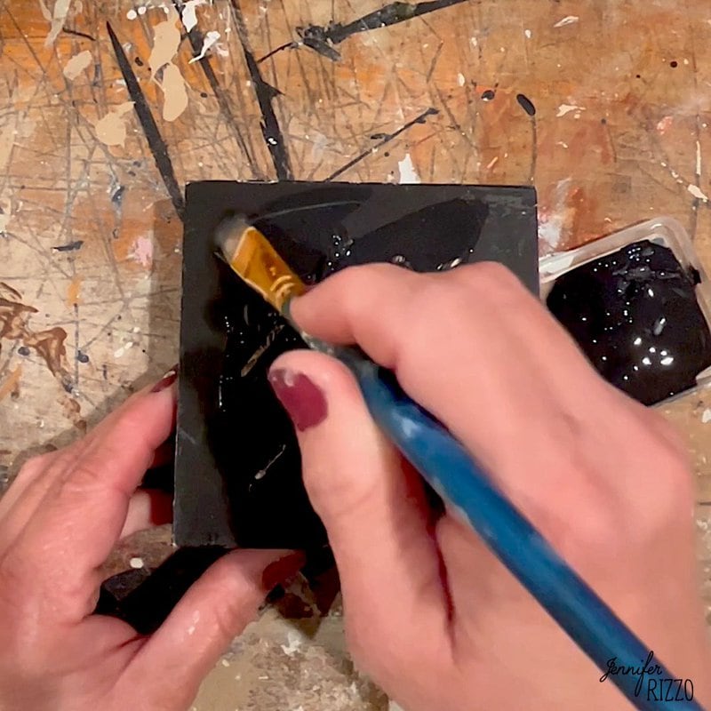 Paint a base coat of black paint on the surface