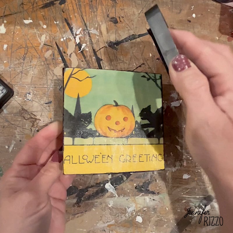 Use a stamp pad to add aging to the edges of the canvas