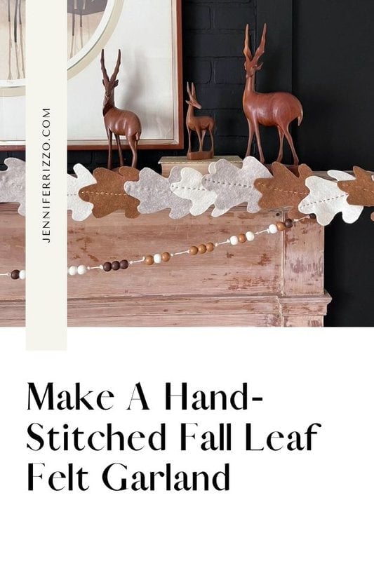A wooden mantel is decorated with a fall-themed garland made of hand-stitched felt leaves and wooden beads. There are wooden deer figurines placed on top of the mantel. Text above reads: "Make A Hand-Stitched Fall Leaf Felt Garland.