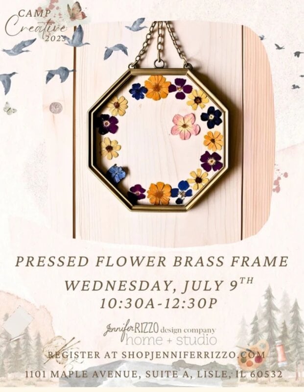 A hexagonal brass frame with pressed flowers hangs on a wooden background. Text provides event details for a pressed flower brass frame workshop on July 9th, 10:30AM–12:30PM.