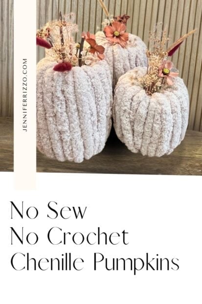Three decorative chenille pumpkins with artificial flowers on top, displayed on a wooden surface. Text reads: “No Sew No Crochet Chenille Pumpkins.”.