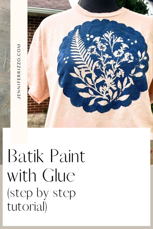 Person wearing a light pink t-shirt with a large blue batik-style floral design on the front; text overlay reads "Batik with Glue and Stencils (step by step tutorial)".
