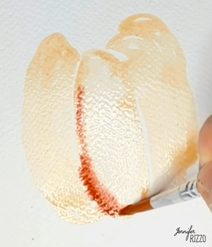 A hand uses a paintbrush to apply red watercolor paint to a light peach wash on textured paper. The artist’s signature, “Jennifer Rizzo,” appears in the lower right corner.