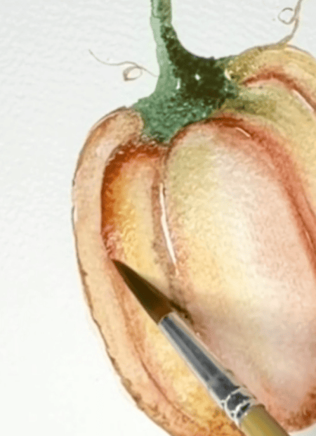 A paintbrush adds red shading to a watercolor painting of a bell pepper on textured white paper.