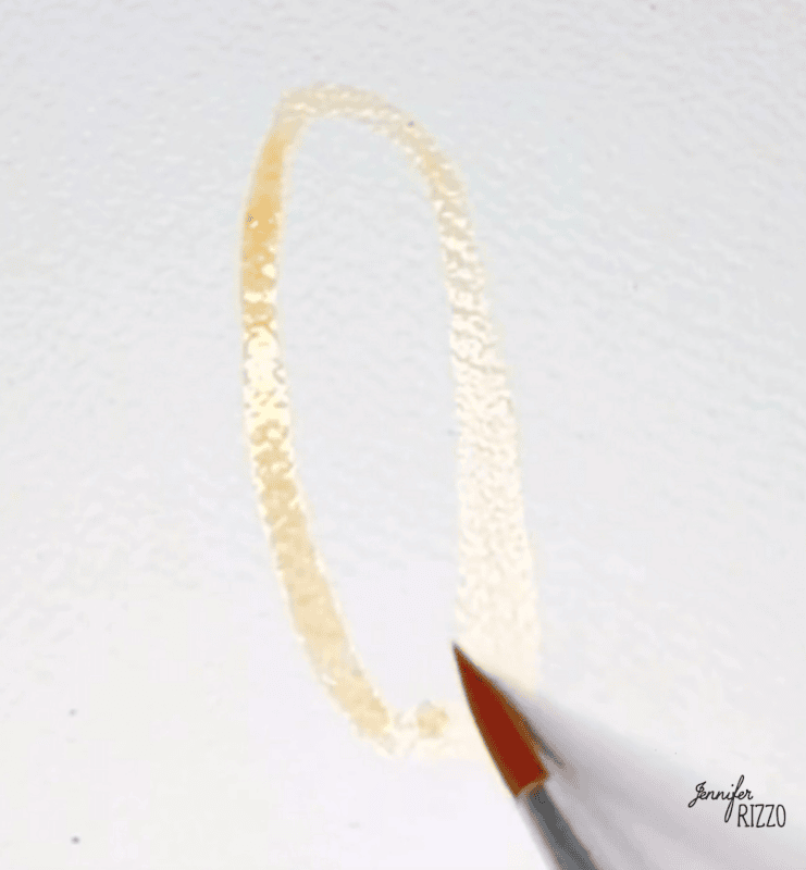 A paintbrush is drawing a light, oval-shaped outline on white textured paper.