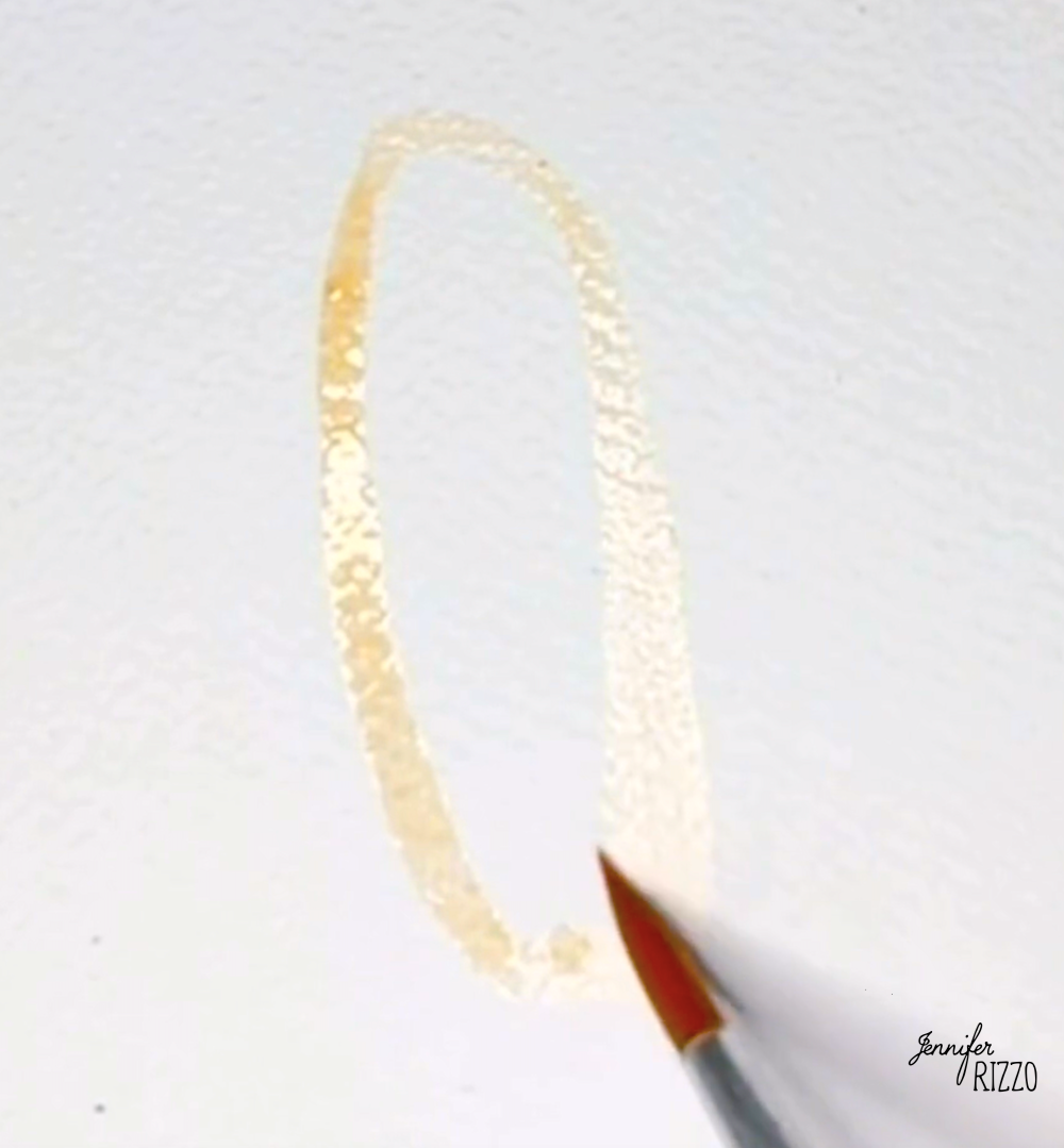 A paintbrush is drawing a light, oval-shaped outline on white textured paper.