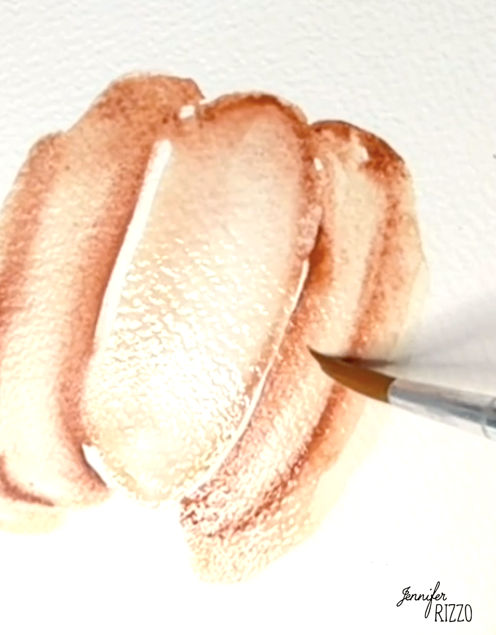 A paintbrush applies light brown watercolor strokes onto textured white paper, creating overlapping shapes.
