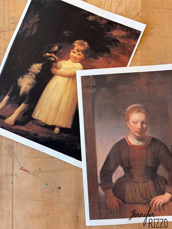 Two printed portraits on a wooden surface: one of a child with a dog, and one of a young woman in dark clothing.