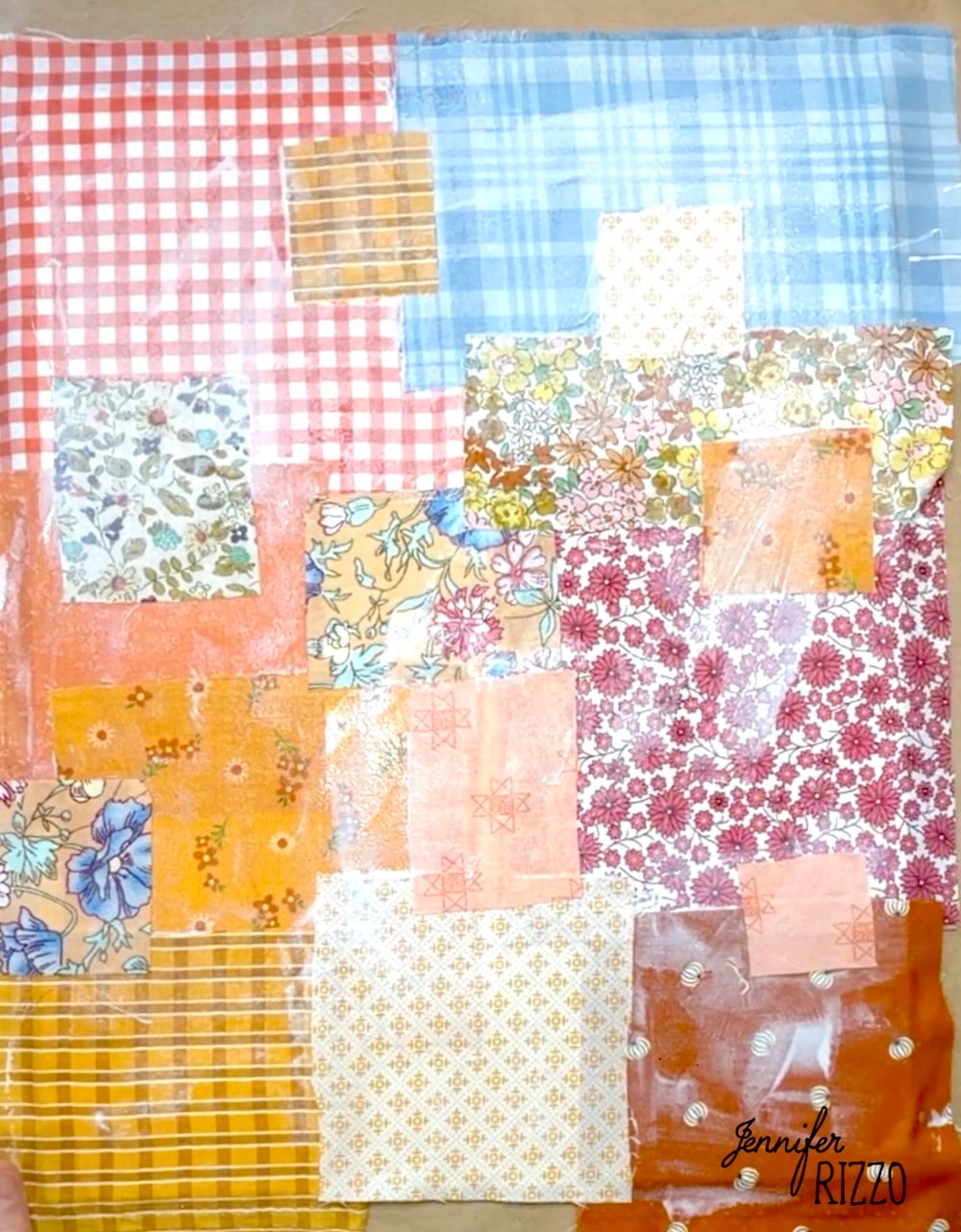 A collage of various patterned fabric squares in different colors, including floral, plaid, and checkered designs, arranged in a patchwork style.