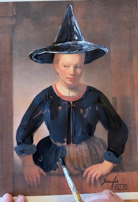 A person paints a witch hat and dark dress over a classical portrait of a woman, transforming her appearance with black paint.